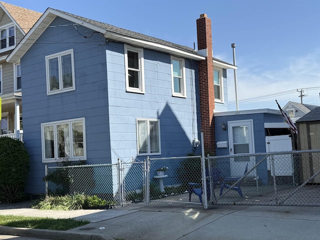 207 W Maple Ave, Wildwood, NJ 08260 - back of property featuring fence, a gate, and a chimney