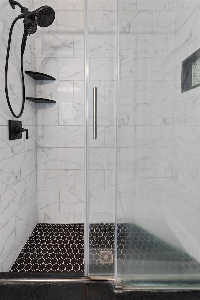 bathroom with a shower with shower door