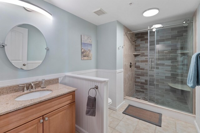 bathroom featuring an enclosed shower, tile patterned floors, vanity, and toilet