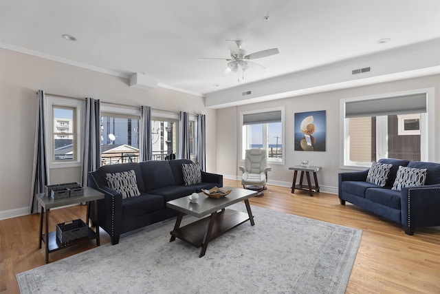 living room with ceiling fan, light hardwood / wood-style flooring, and crown molding