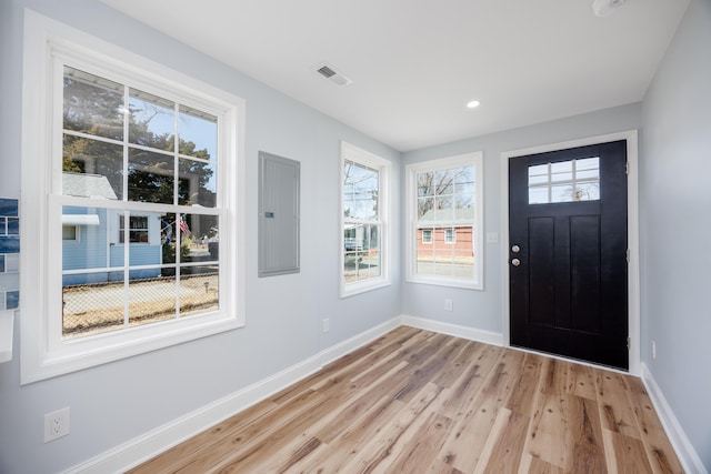 entrance foyer featuring light wood finished floors, recessed lighting, electric panel, and baseboards