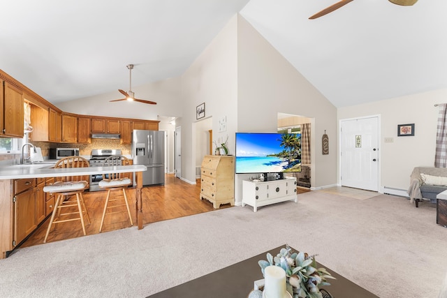1431 Burleigh Rd, Green Creek, NJ 08210 - kitchen featuring a ceiling fan, appliances with stainless steel finishes, light carpet, high vaulted ceiling, and a sink