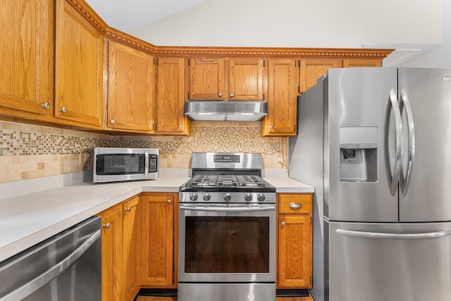 1431 Burleigh Rd, Green Creek, NJ 08210 - kitchen featuring appliances with stainless steel finishes, under cabinet range hood, light countertops, brown cabinets, and vaulted ceiling