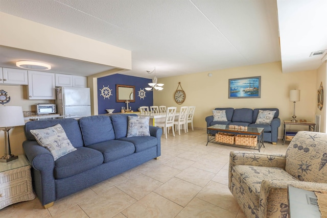 living room with light tile patterned floors and a notable chandelier