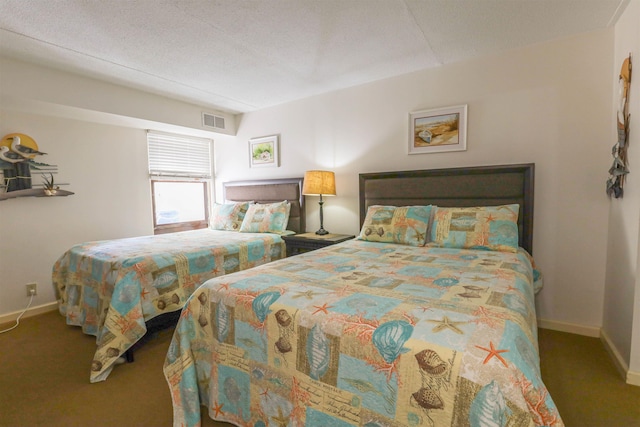 bedroom featuring carpet and a textured ceiling