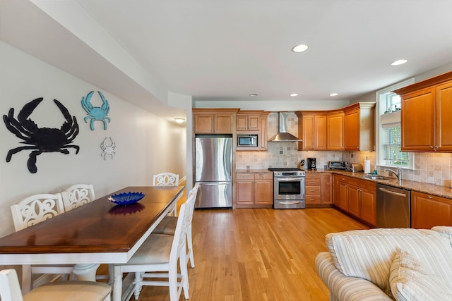 2025 Dune Dr Unit 2025, Avalon, NJ 08202 - kitchen with appliances with stainless steel finishes, wall chimney exhaust hood, light stone countertops, decorative backsplash, and recessed lighting