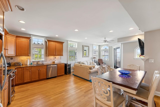 2025 Dune Dr Unit 2025, Avalon, NJ 08202 - kitchen featuring stainless steel appliances, light wood finished floors, brown cabinetry, recessed lighting, and stone counters