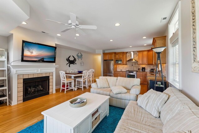 2025 Dune Dr Unit 2025, Avalon, NJ 08202 - living area with a tiled fireplace, ceiling fan, recessed lighting, and light wood-type flooring