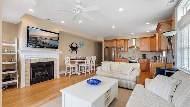 2025 Dune Dr Unit 2025, Avalon, NJ 08202 - living room with light wood finished floors, a ceiling fan, recessed lighting, and a fireplace