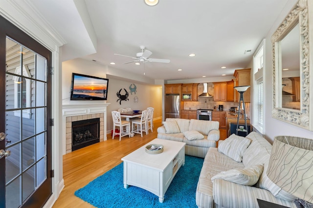 2025 Dune Dr Unit 2025, Avalon, NJ 08202 - living room featuring light wood-type flooring, a tile fireplace, a ceiling fan, and recessed lighting