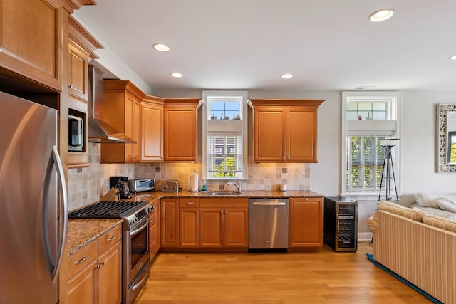2025 Dune Dr Unit 2025, Avalon, NJ 08202 - kitchen with stainless steel appliances, wall chimney exhaust hood, stone counters, light wood-style floors, and recessed lighting