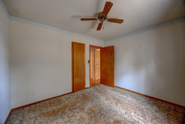 empty room featuring ceiling fan and carpet flooring