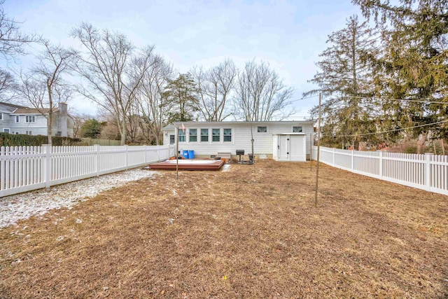 back of house featuring a wooden deck and a yard