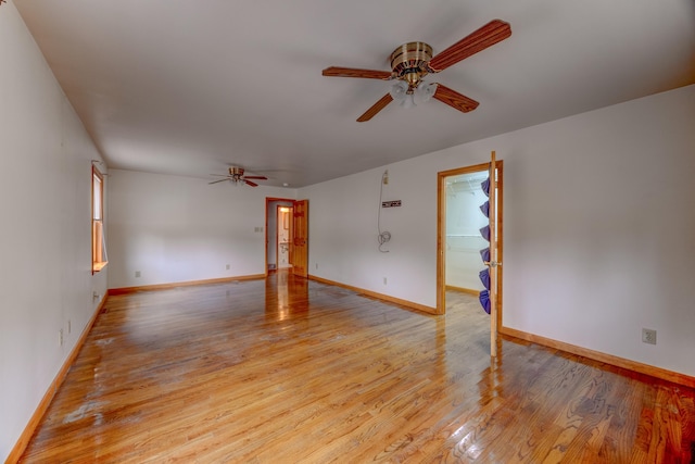 empty room with light hardwood / wood-style floors and ceiling fan