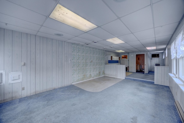 basement with a drop ceiling and carpet floors