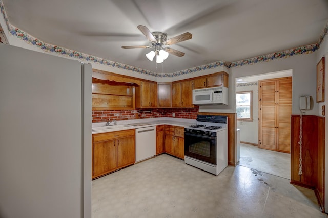 kitchen featuring sink, backsplash, white appliances, and ceiling fan