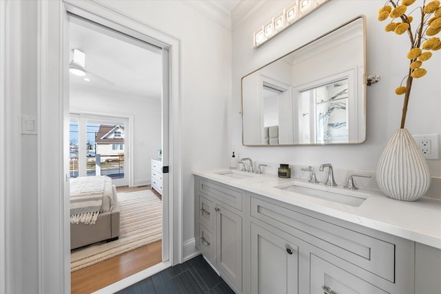 bathroom featuring ornamental molding and vanity