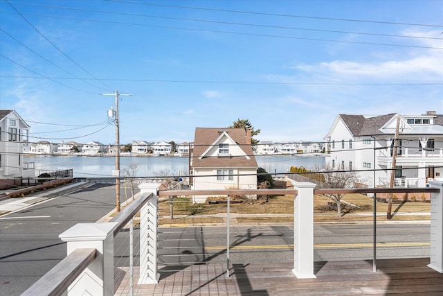 wooden terrace featuring a water view