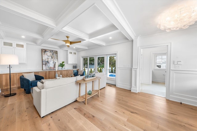 living room featuring coffered ceiling, beam ceiling, light hardwood / wood-style floors, and crown molding