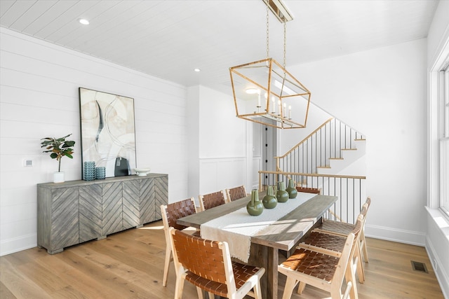 274 106th St, Stone Harbor, NJ 08247 - dining area with light wood finished floors, a chandelier, recessed lighting, stairway, and wood walls