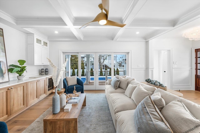 living room with french doors, coffered ceiling, beam ceiling, and light hardwood / wood-style floors