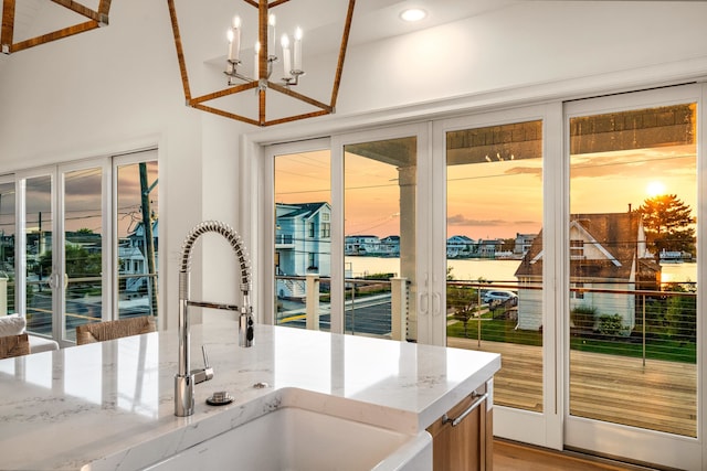 274 106th St, Stone Harbor, NJ 08247 - kitchen featuring a chandelier, light stone counters, healthy amount of natural light, and recessed lighting