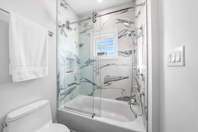 bathroom featuring shower / bath combination with glass door and toilet