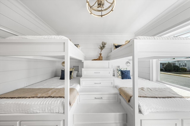 bedroom featuring ornamental molding and wooden walls