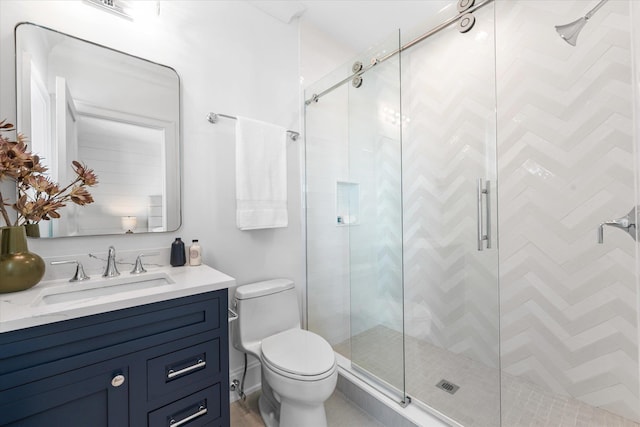 bathroom featuring vanity, an enclosed shower, and toilet