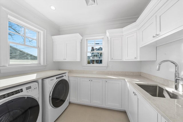 laundry room with cabinets, crown molding, sink, and independent washer and dryer