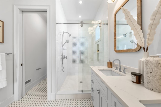 bathroom with vanity and a shower with shower door