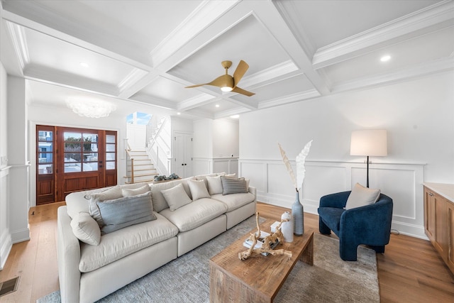 living room featuring coffered ceiling, beam ceiling, and light hardwood / wood-style flooring