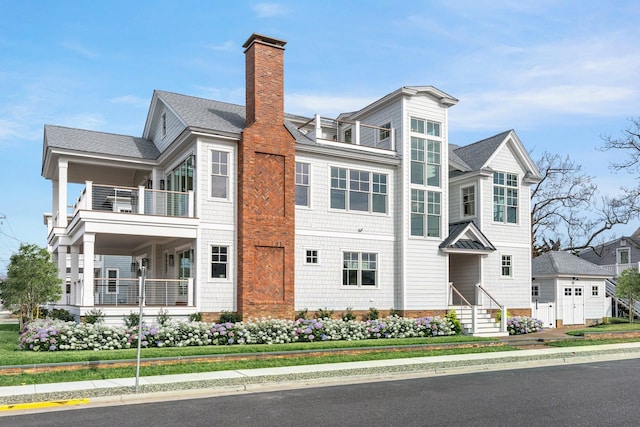 274 106th St, Stone Harbor, NJ 08247 - view of front of home featuring a balcony, a chimney, and roof with shingles