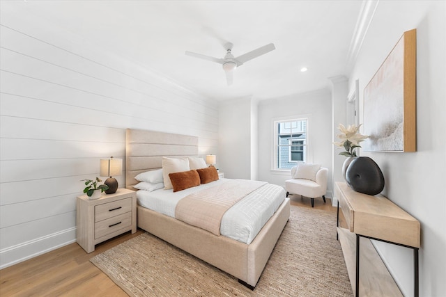 bedroom featuring ornamental molding, ceiling fan, and light wood-type flooring