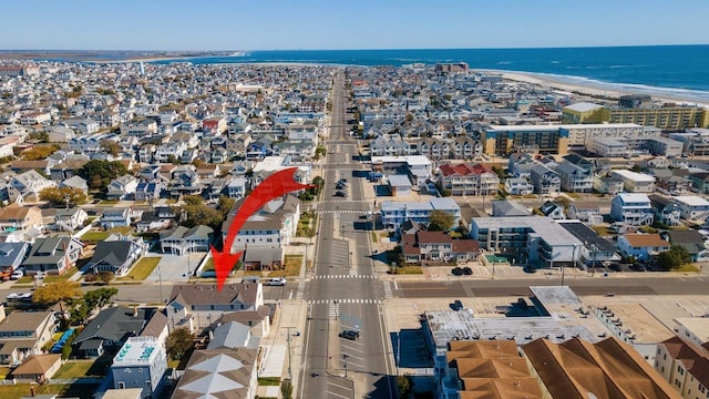 drone / aerial view featuring a water view and a beach view