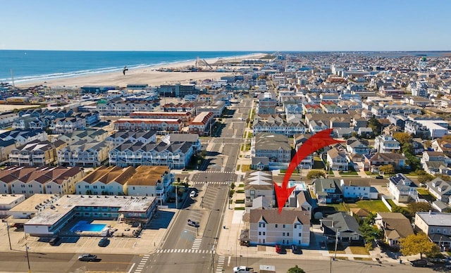 drone / aerial view with a beach view and a water view