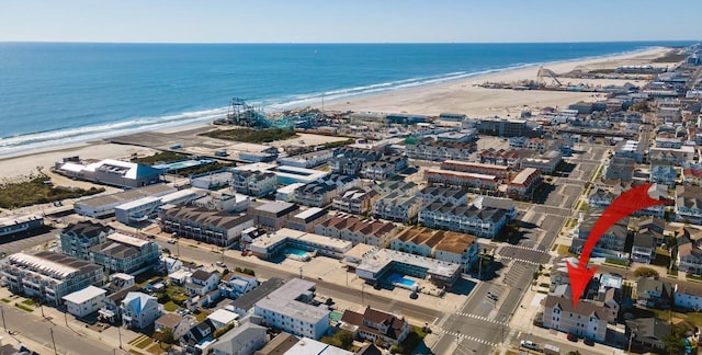 drone / aerial view with a water view and a beach view