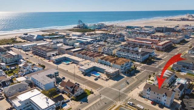 bird's eye view featuring a water view and a view of the beach