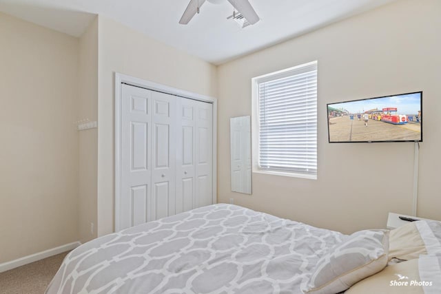 bedroom with multiple windows, carpet floors, a closet, and ceiling fan