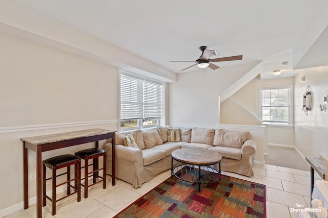 living room with ceiling fan, light tile patterned floors, and a healthy amount of sunlight