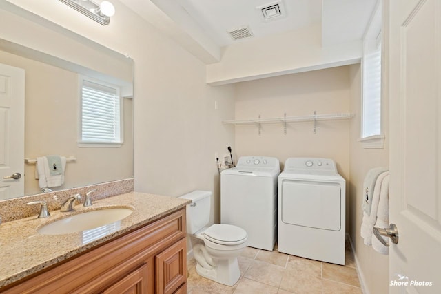 bathroom with tile patterned floors, toilet, vanity, and independent washer and dryer