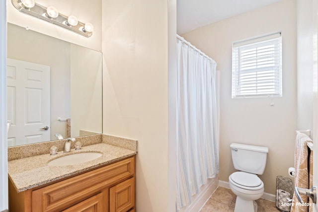 bathroom featuring toilet, vanity, and tile patterned floors