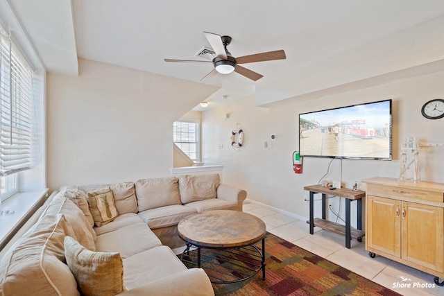 living room featuring plenty of natural light, ceiling fan, and light tile patterned flooring