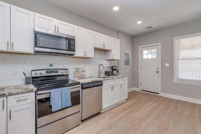222 E Burk Ave Unit 4, Wildwood, NJ 08260 - kitchen with appliances with stainless steel finishes, a sink, light wood finished floors, white cabinetry, and recessed lighting