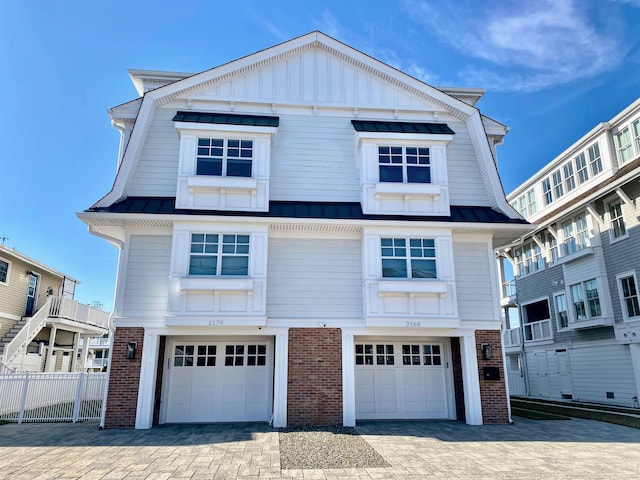 6762 Ocean Dr Unit 6762, Avalon, NJ 08202 - view of front of home with brick siding, a garage, a standing seam roof, and driveway