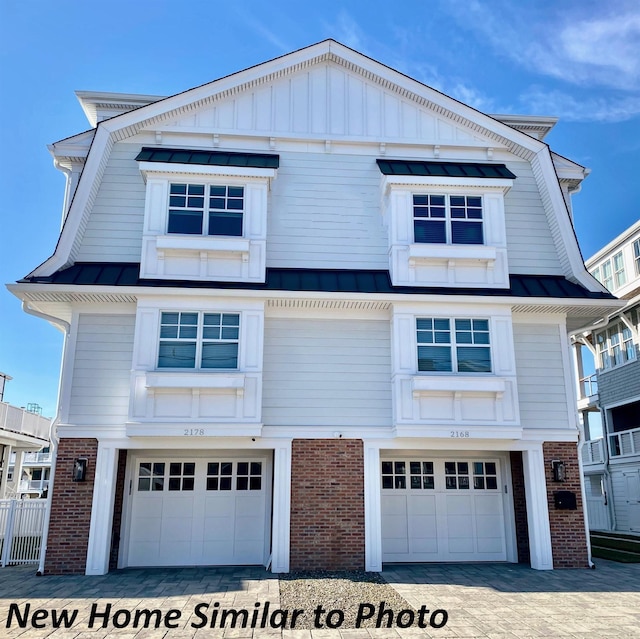 6762 Ocean Dr Unit 6762, Avalon, NJ 08202 - view of front of property featuring brick siding, an attached garage, a metal roof, and a standing seam roof