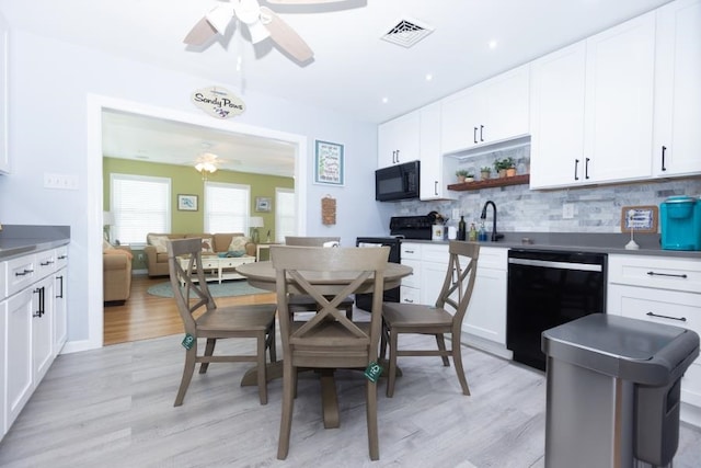 213 Hollywood Ave, Villas, NJ 08251 - kitchen with ceiling fan, black appliances, tasteful backsplash, light wood-style floors, and open shelves