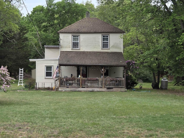 1121 Sumner Ave, Woodbine, NJ 08270 - view of front of home with a shingled roof, a front yard, a chimney, and covered porch
