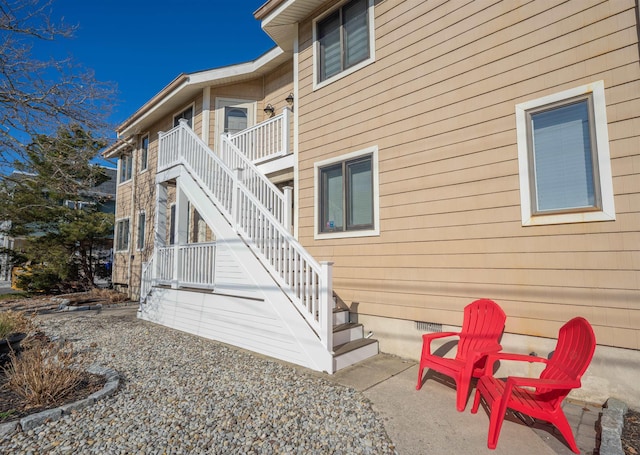 exterior space with stairs and a patio