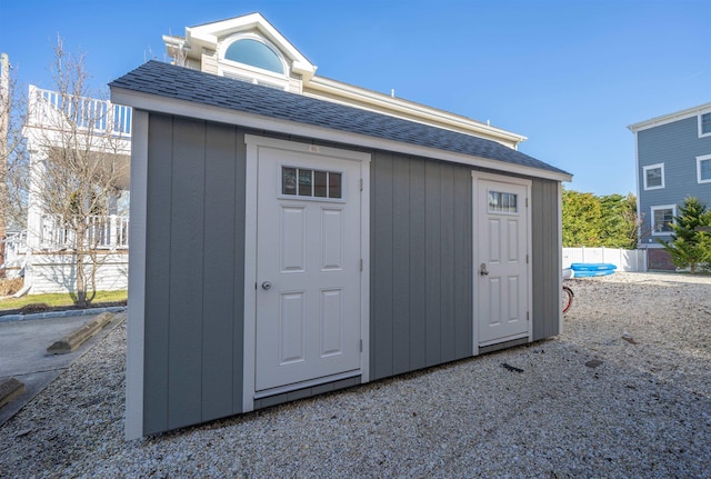 view of shed with fence